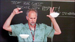 Warren Central High School science teacher Jeff Steinbronn uses coffee filters to demonstrate air resistance in his advanced physics class.