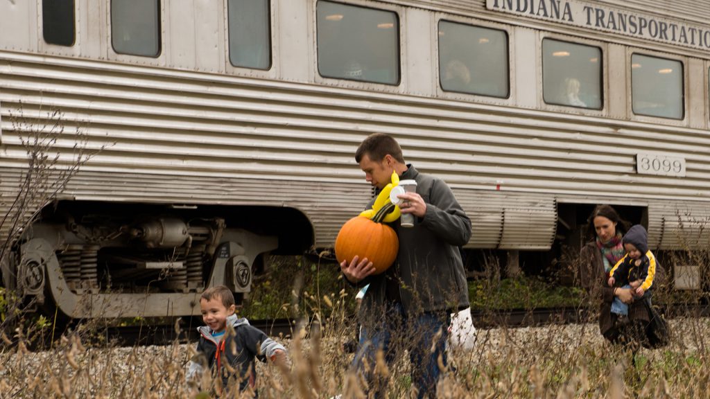 Josh and Lacie Stowers, along with sons Oren (left) and Mason, head back to the train with full hands.