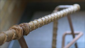 Stairwell handrails leading to upper floors are encased in rope.