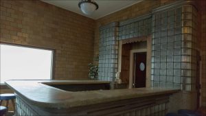 The adjacent bar, whose woodwork and decorative glass still capture the original era, will be converted to a coffee bar.