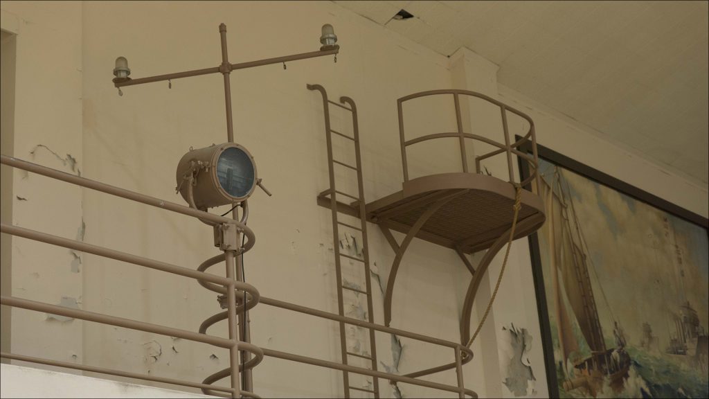 Two iron ladders at one end of the gym, on the mezzanine level, provide access to nautical-themed lookout stations.