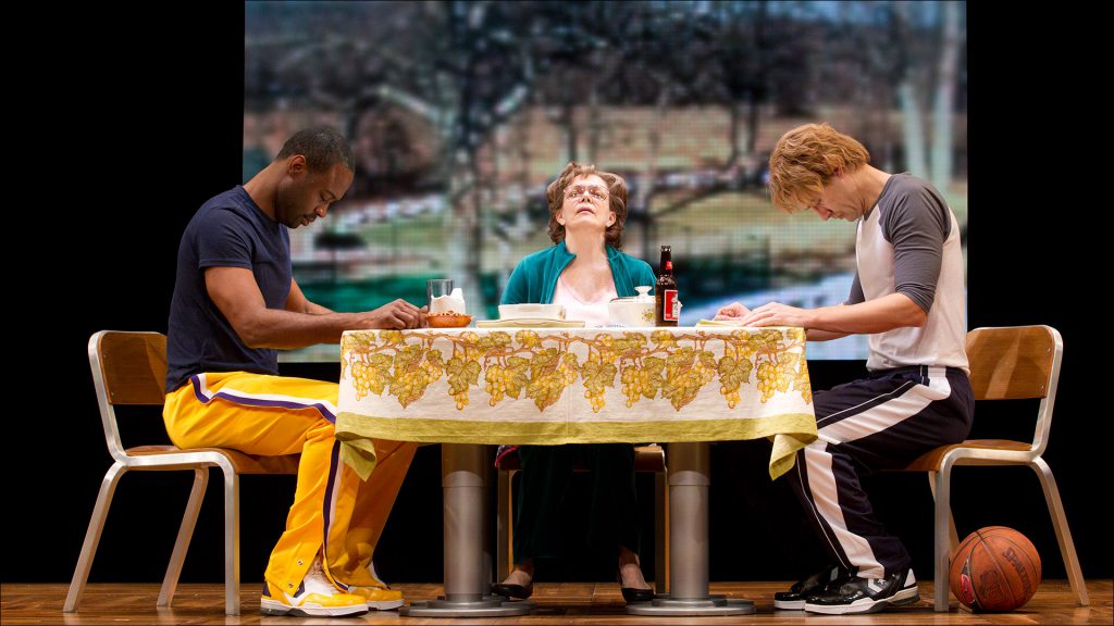 Earvin ''Magic'' Johnson (Kevin Daniels) and chief basketball rival Larry Bird (Tug Coker, right) break bread in the home of Bird's mother (played by Deidre O'Connell.)