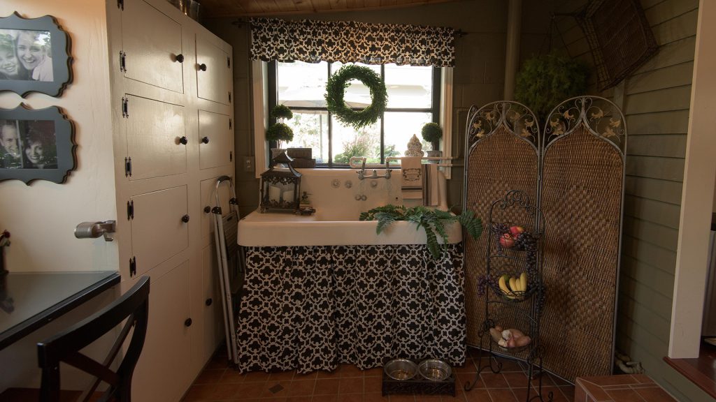 A large farmhouse sink in the utility room dates to the home's era.