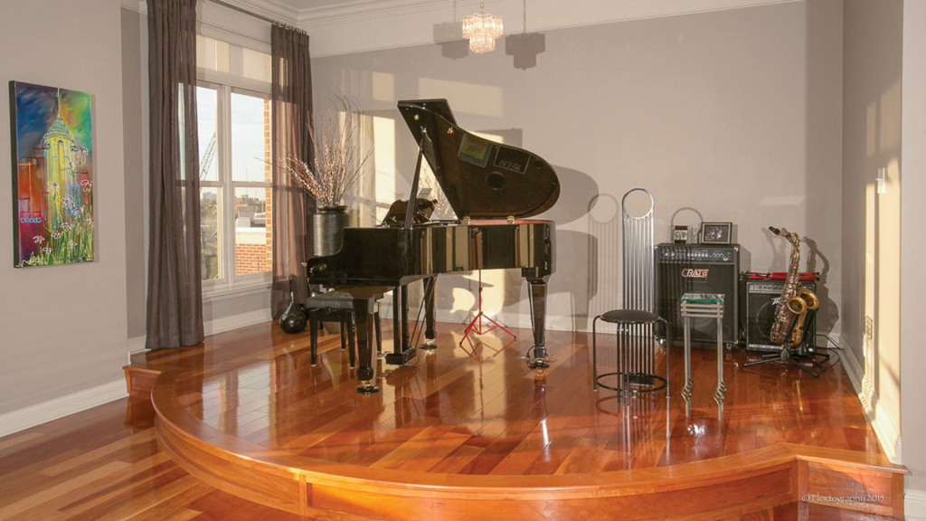 A small stage typically is home to a baby grand piano but can be used for bands or other entertainment during parties.