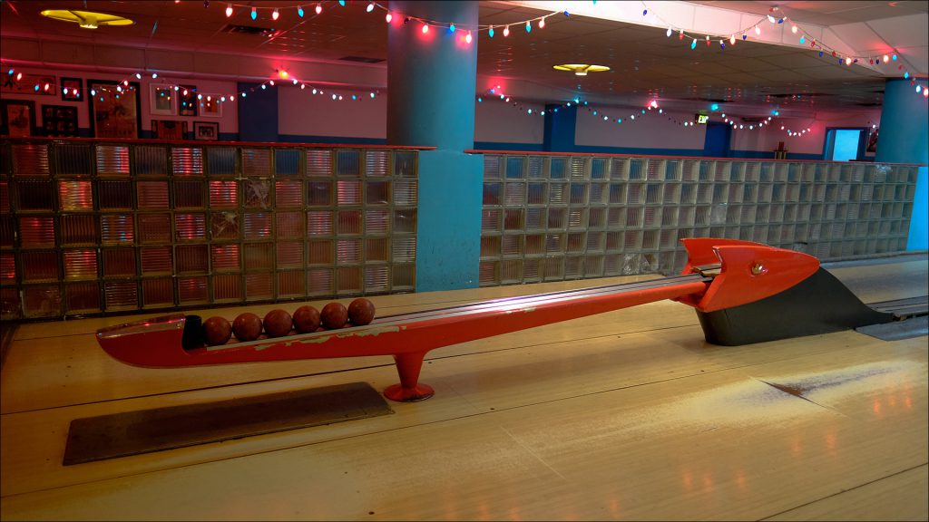Duckpin bowling uses shorter, wider pins and smaller, lighter balls-without finger holes.