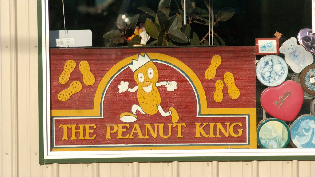 A vintage Peanut King sign in Richard Green Co.'s window. The Indianapolis company got its start in 1957 selling peanut vending machines.