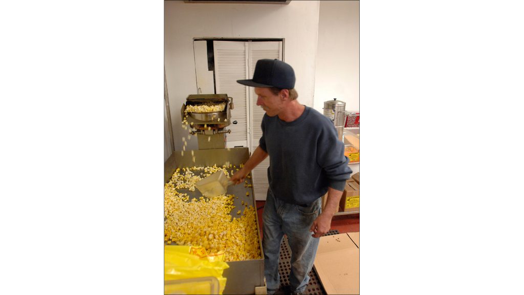 Employee Jay Hess makes popcorn, which is more profitable than many other snacks, the Greens say.