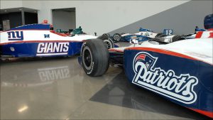 The Super Bowl XLVI combatants are represented on two Indy cars decorated for Super Bowl week.