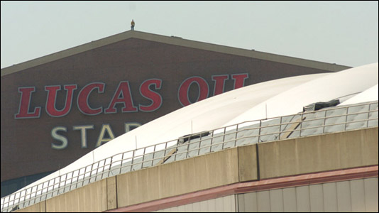 A man watches from the roof of Lucas Oil Stadium.