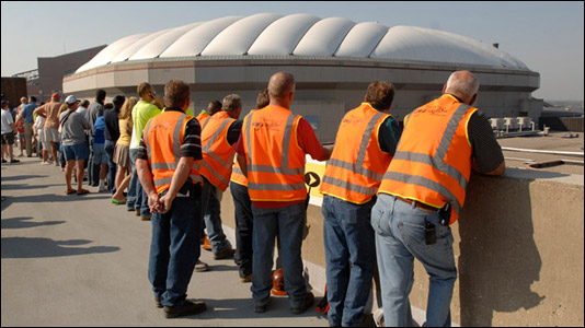 Workers from Sabre Demolition Corp., a New York company that is taking down the dome, watch from a parking garage.