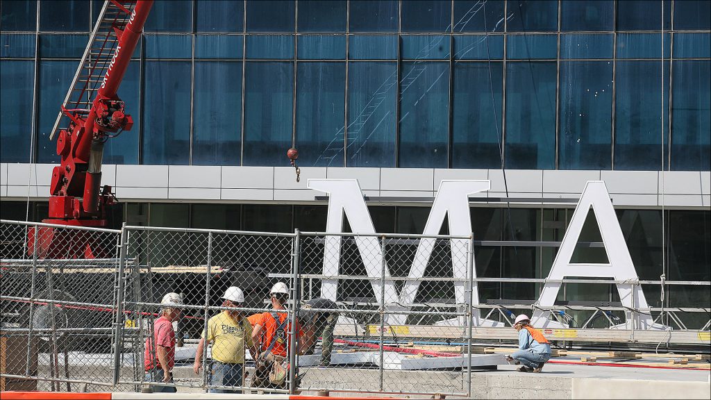 Crews gave the JW Marriott an identity in September, hoisting giant letters to the top of the 34-story hotel downtown.