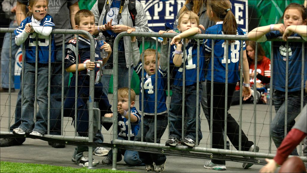 Pint-size fans-including at least one New England loyalist-wait for their turn to catch a touchdown pass.