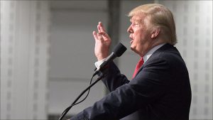 Donald Trump told a crowd of thousands that he will tax imports high enough to ensure that companies have a reason to manufacture goods in the United States.