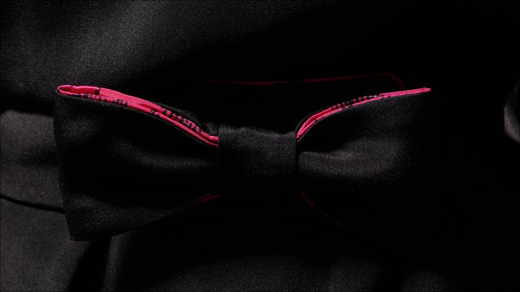 The pink lining draws attention to the bow belt, however a thin leather belt in a bright color like teal could add a splash of color to the dress.