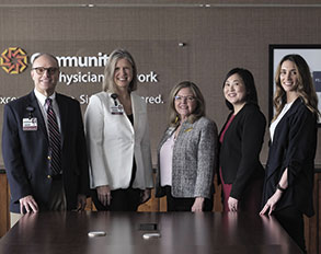 Five members of Community Health Network's Center for Physician Well-Being and Professional Development posed behind a conference table.