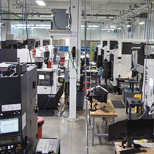 A large industrial workplace filled with workstations connected by network cabling