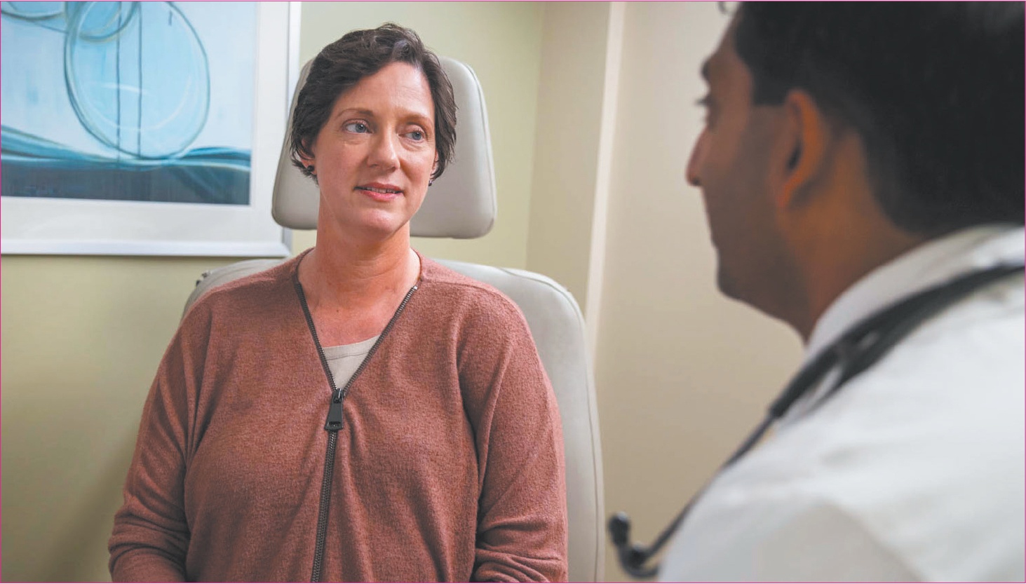 A woman speaks with a doctor.