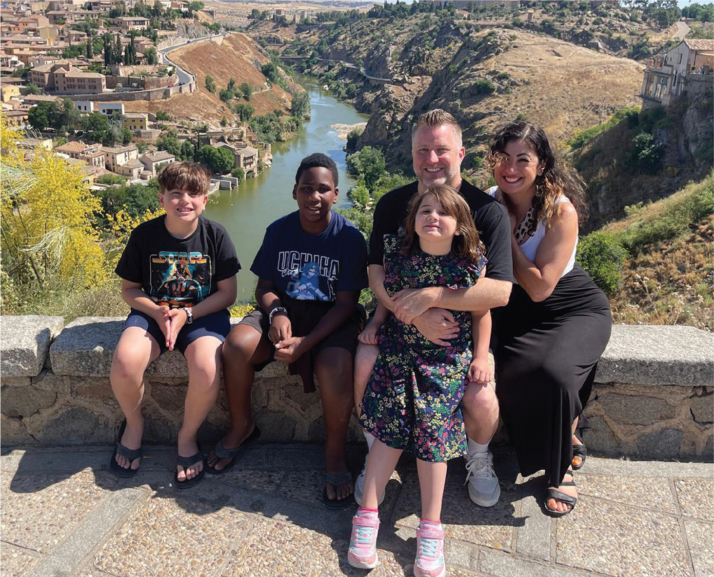 Photograph of a smiling famiy of five on vacation