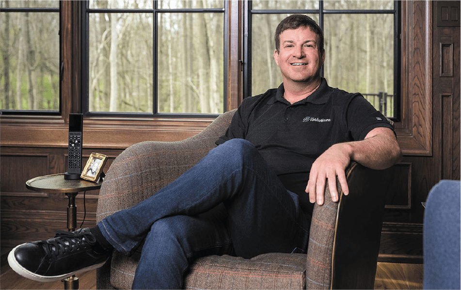 A member of iSolutions Payments LLC seated in an armchair