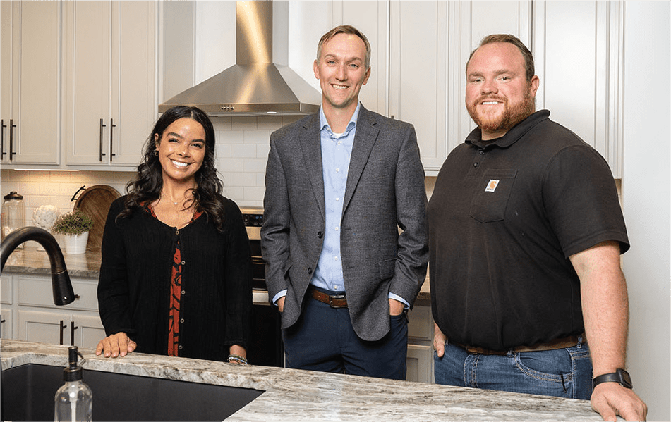 3 members of Hallmark Homes Inc posed in a kitchen