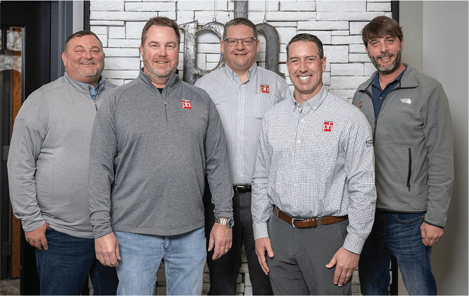 5 members of Patterson Horth Inc posed in their office